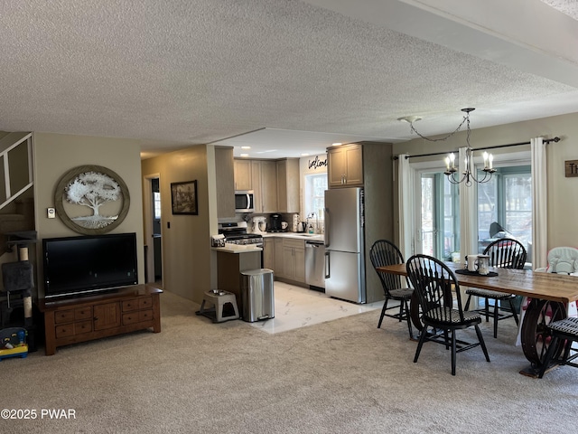 dining area featuring a chandelier, plenty of natural light, light colored carpet, and a textured ceiling