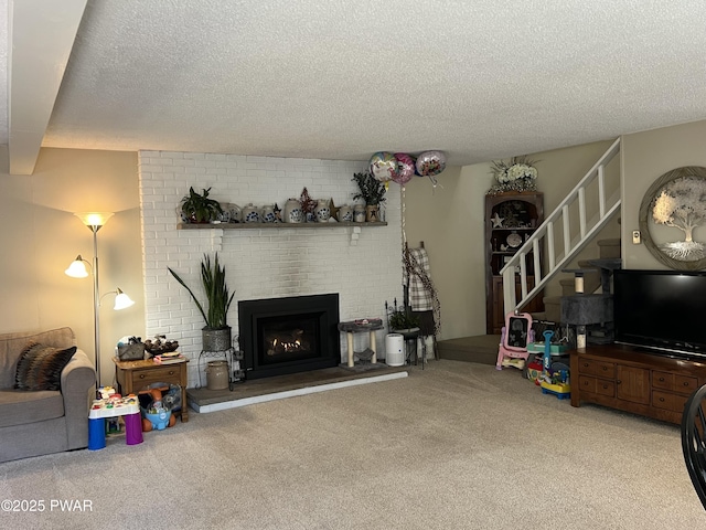 carpeted living room with a brick fireplace, stairway, and a textured ceiling