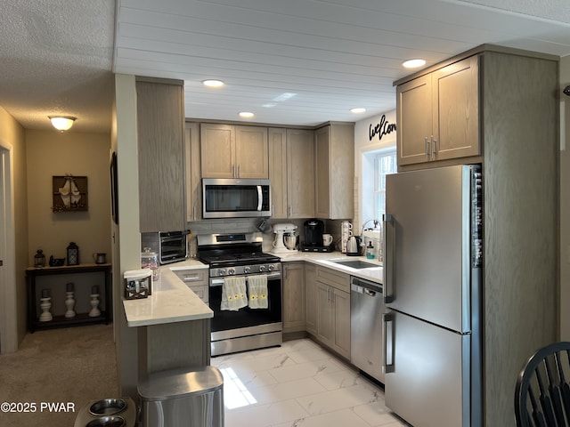 kitchen with tasteful backsplash, recessed lighting, appliances with stainless steel finishes, marble finish floor, and a sink