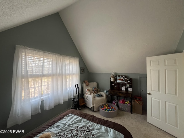 bedroom featuring vaulted ceiling, carpet floors, and a textured ceiling