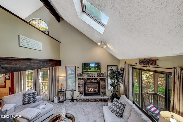 living room featuring a brick fireplace, carpet flooring, vaulted ceiling with skylight, and a textured ceiling