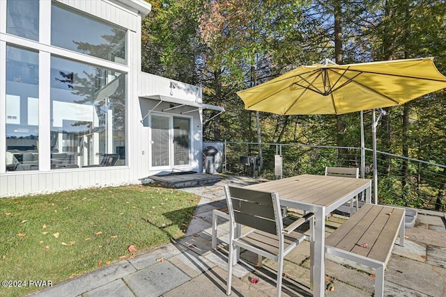 wooden terrace featuring a lawn