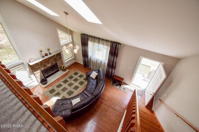 139 Westwood Dr, Dingmans Ferry, PA 18328 - living room with a skylight, a fireplace, wood finished floors, and lofted ceiling