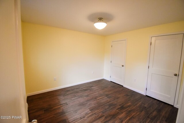 139 Westwood Dr, Dingmans Ferry, PA 18328 - unfurnished bedroom with dark wood-type flooring and baseboards
