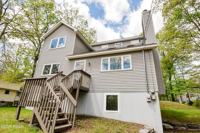 139 Westwood Dr, Dingmans Ferry, PA 18328 - back of house featuring a chimney, a deck, and stairway