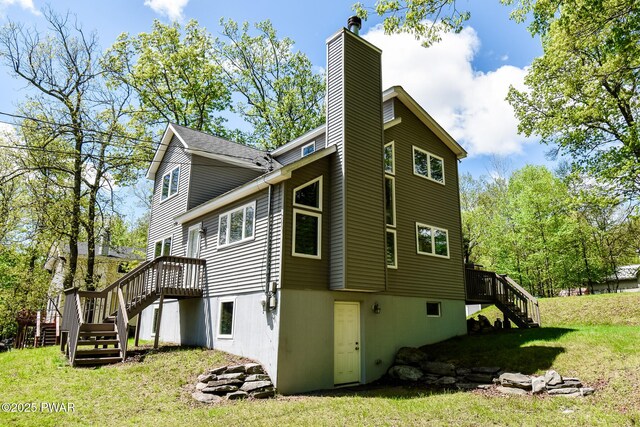 139 Westwood Dr, Dingmans Ferry, PA 18328 - view of home's exterior with stairs, a chimney, a lawn, and a wooden deck