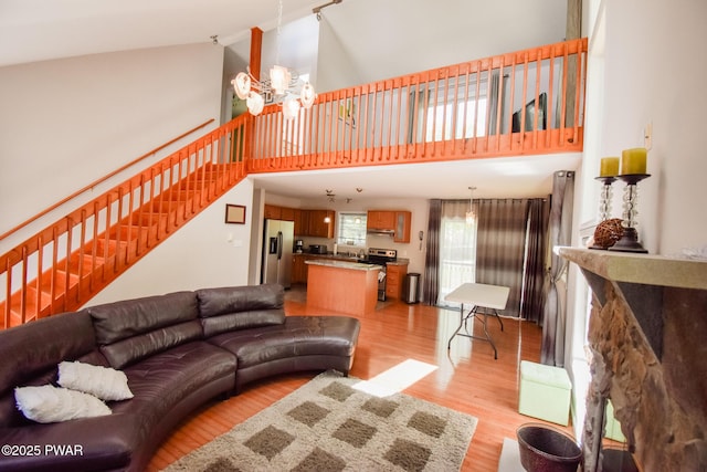 139 Westwood Dr, Dingmans Ferry, PA 18328 - living room featuring light wood-style floors, high vaulted ceiling, and stairway