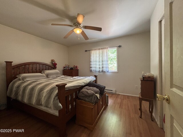 130 Roundhill Rd, Dingmans Ferry, PA 18328 - bedroom featuring light wood-style flooring, a baseboard radiator, and ceiling fan