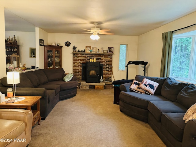 living room with light colored carpet, a wood stove, and ceiling fan