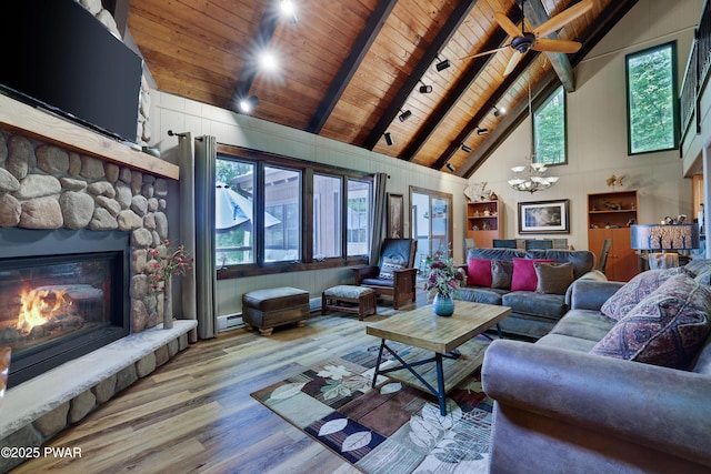 102 Lake Run, Greentown, PA 18426 - living area with a wooden ceiling with exposed beams, high vaulted ceiling, wood finished floors, a stone fireplace, and a chandelier