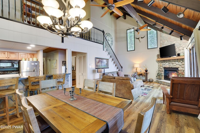 102 Lake Run, Greentown, PA 18426 - dining area featuring a ceiling fan, light wood-style flooring, beamed ceiling, a chandelier, and high vaulted ceiling