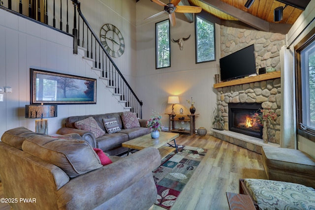 102 Lake Run, Greentown, PA 18426 - living room with wood-type flooring, high vaulted ceiling, a stone fireplace, beam ceiling, and ceiling fan