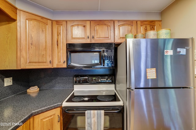 102 Lake Run, Greentown, PA 18426 - kitchen featuring freestanding refrigerator, black microwave, electric range oven, dark countertops, and tasteful backsplash