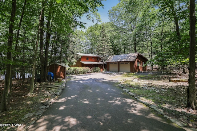 102 Lake Run, Greentown, PA 18426 - view of front of house with a garage, an outbuilding, asphalt driveway, and a metal roof