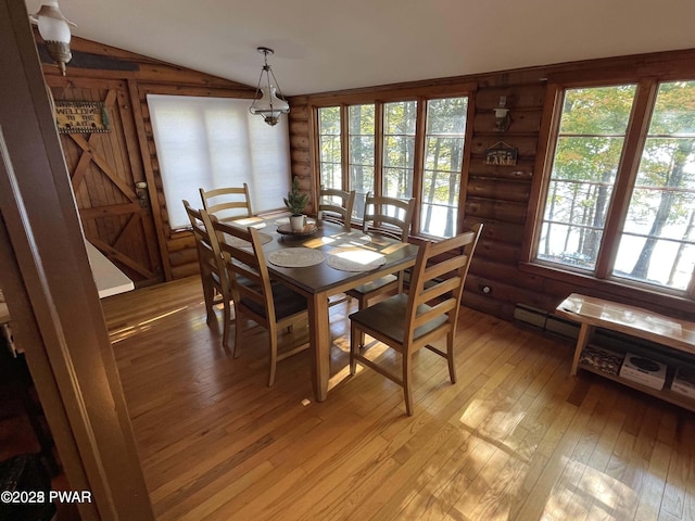 22 Glen Rd, Lake Ariel, PA 18436 - dining room featuring light wood-type flooring, rustic walls, vaulted ceiling, and plenty of natural light