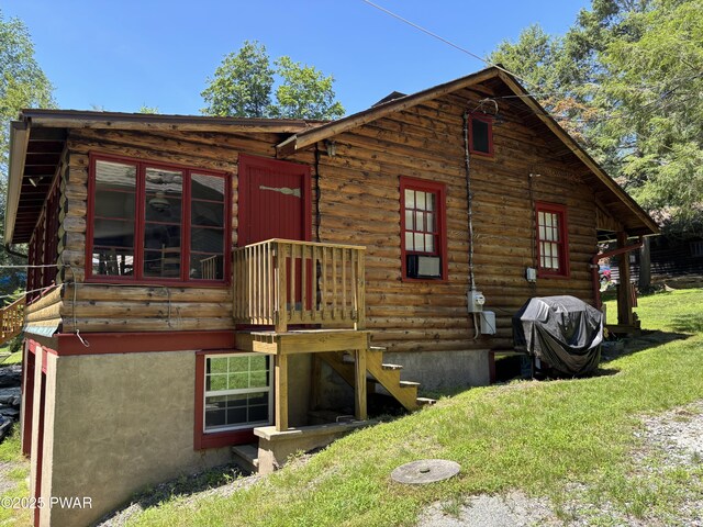22 Glen Rd, Lake Ariel, PA 18436 - rear view of house with log siding and a yard