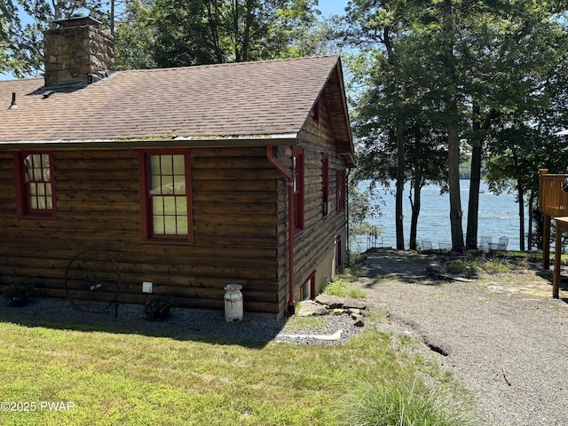 22 Glen Rd, Lake Ariel, PA 18436 - view of side of home with roof with shingles, a chimney, a water view, and a lawn