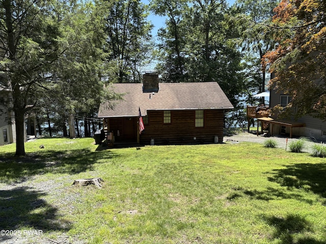 22 Glen Rd, Lake Ariel, PA 18436 - back of property with a chimney, a yard, roof with shingles, and a wooden deck