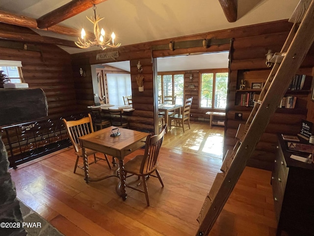 22 Glen Rd, Lake Ariel, PA 18436 - dining room with log walls, hardwood / wood-style floors, a chandelier, and beam ceiling