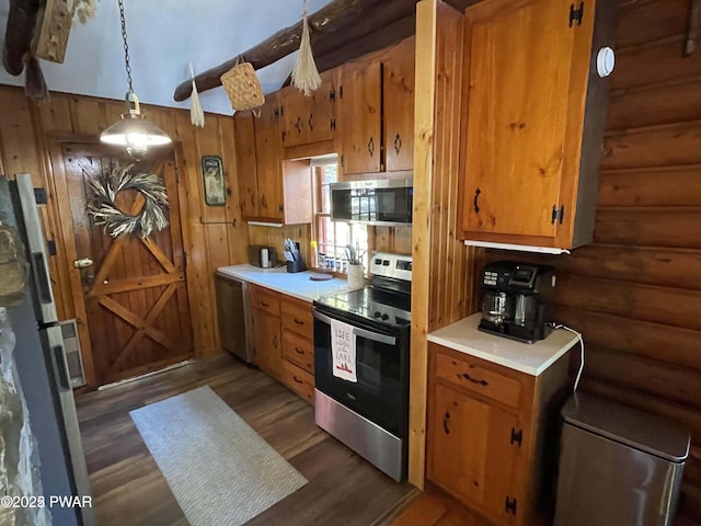 22 Glen Rd, Lake Ariel, PA 18436 - kitchen with appliances with stainless steel finishes, rustic walls, light countertops, wood finished floors, and brown cabinetry