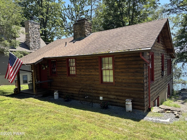 22 Glen Rd, Lake Ariel, PA 18436 - view of property exterior with a lawn, a chimney, a shingled roof, and a garage