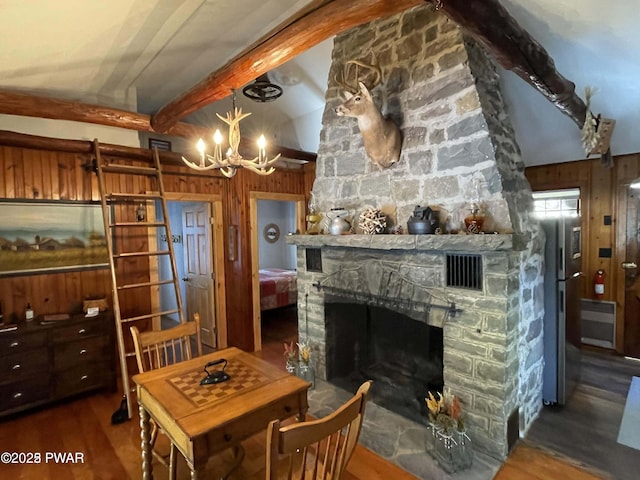22 Glen Rd, Lake Ariel, PA 18436 - dining space with wood walls, a chandelier, wood finished floors, and a fireplace