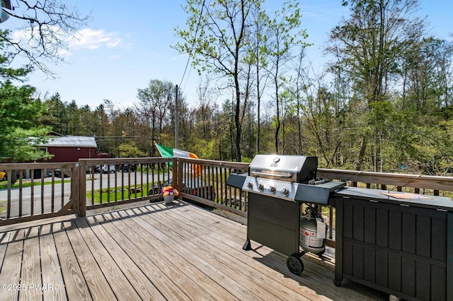deck with grilling area and a playground