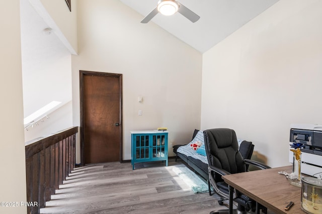 office featuring a ceiling fan, wood finished floors, and high vaulted ceiling