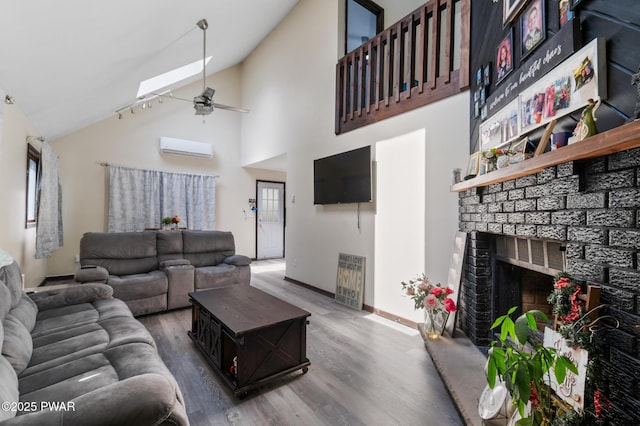 1267 Brookfield Rd, Lake Ariel, PA 18436 - living area with a ceiling fan, wood finished floors, a wall mounted AC, baseboards, and a fireplace with raised hearth