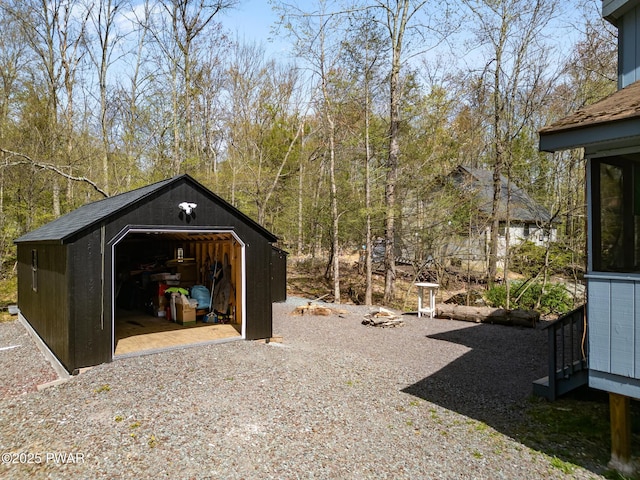 view of yard featuring a garage and an outdoor structure