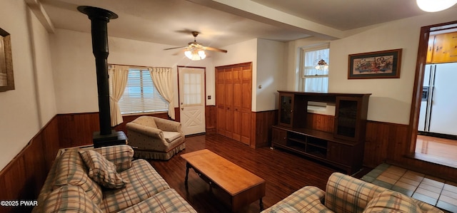 640 Rte 434, Shohola, PA 18458 - living area with a wainscoted wall, a wood stove, wooden walls, ceiling fan, and wood finished floors