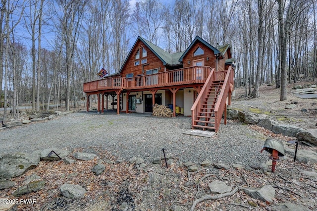 98 Roamingwood Rd, Lake Ariel, PA 18436 - rear view of property with stucco siding, a deck, and stairs