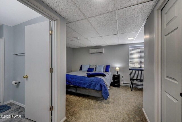 98 Roamingwood Rd, Lake Ariel, PA 18436 - bedroom featuring a baseboard heating unit, a drop ceiling, baseboards, a wall mounted air conditioner, and carpet floors