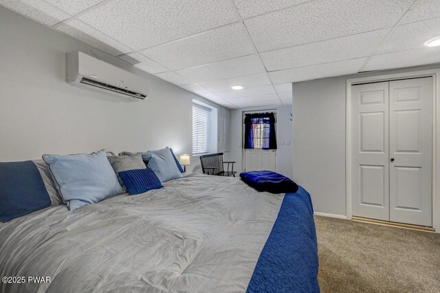 98 Roamingwood Rd, Lake Ariel, PA 18436 - carpeted bedroom featuring an AC wall unit, baseboards, a drop ceiling, and a closet