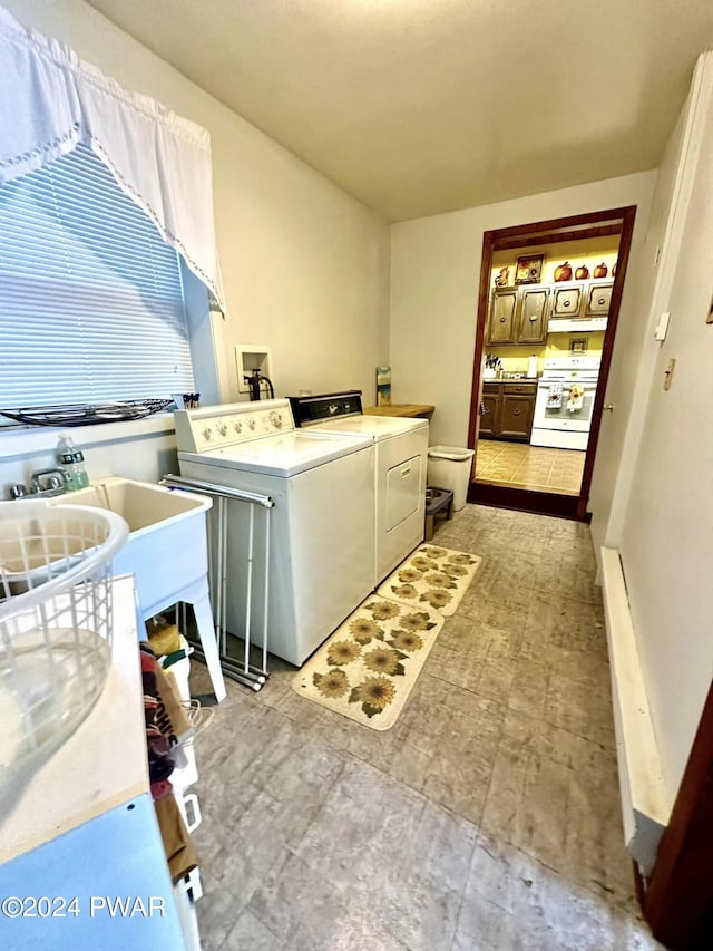 washroom featuring washer and dryer and sink