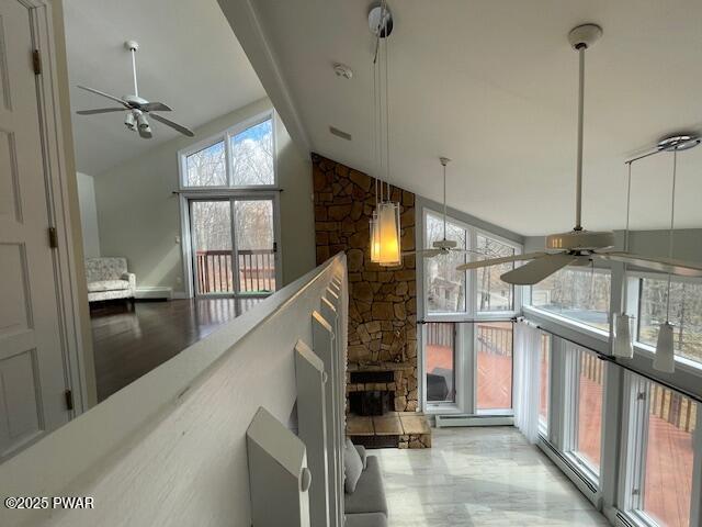 interior space featuring baseboard heating and ceiling fan