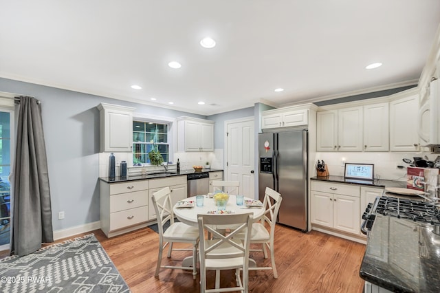 136 Weasel Rd, Dingmans Ferry, PA 18328 - kitchen with stainless steel appliances, backsplash, light wood-style flooring, white cabinets, and crown molding