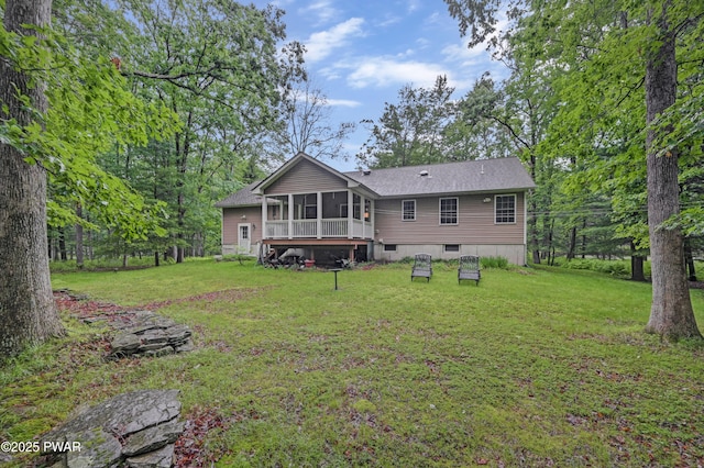 136 Weasel Rd, Dingmans Ferry, PA 18328 - back of house featuring a sunroom, a lawn, and a shingled roof