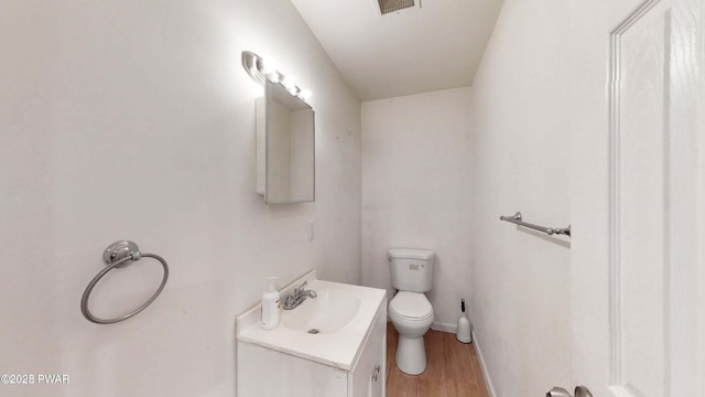 152 Fairview Dr, Dingmans Ferry, PA 18328 - bathroom featuring vanity, toilet, wood finished floors, and baseboards