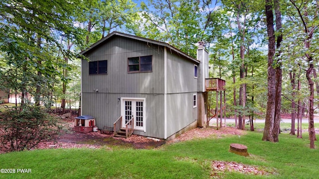 152 Fairview Dr, Dingmans Ferry, PA 18328 - back of house featuring entry steps, french doors, a chimney, and a yard