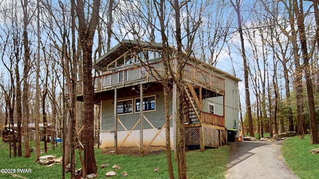 152 Fairview Dr, Dingmans Ferry, PA 18328 - view of front of house with stairs, a front lawn, driveway, and a wooden deck