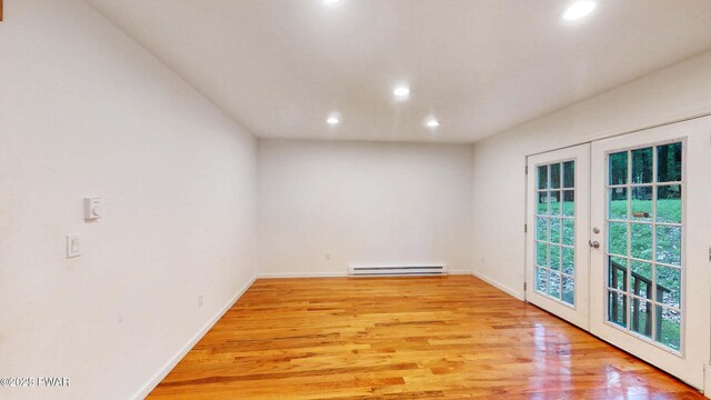 152 Fairview Dr, Dingmans Ferry, PA 18328 - unfurnished room featuring a baseboard radiator, recessed lighting, french doors, light wood-style flooring, and baseboards