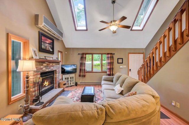 108 Minnow Ct, Lackawaxen, PA 18435 - living area featuring a skylight, ceiling fan, wood finished floors, a fireplace, and high vaulted ceiling