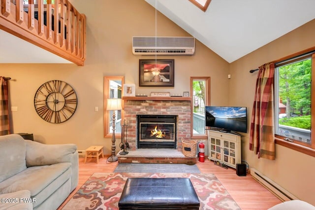 108 Minnow Ct, Lackawaxen, PA 18435 - living room with a baseboard radiator, a wall unit AC, wood finished floors, high vaulted ceiling, and plenty of natural light