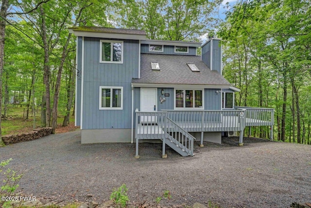 108 Minnow Ct, Lackawaxen, PA 18435 - view of front of home featuring roof with shingles, a wooden deck, and a chimney