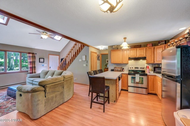 108 Minnow Ct, Lackawaxen, PA 18435 - kitchen featuring appliances with stainless steel finishes, under cabinet range hood, a peninsula, light wood-type flooring, and light countertops