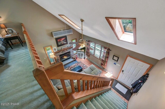 108 Minnow Ct, Lackawaxen, PA 18435 - stairs featuring a ceiling fan, high vaulted ceiling, a skylight, an AC wall unit, and a stone fireplace
