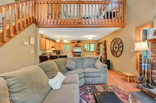 108 Minnow Ct, Lackawaxen, PA 18435 - living area featuring light wood-style flooring, a high ceiling, and baseboard heating