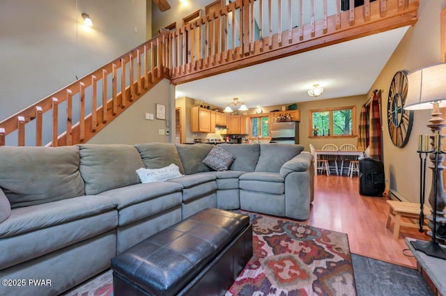 108 Minnow Ct, Lackawaxen, PA 18435 - living area with wood finished floors, a towering ceiling, and stairway