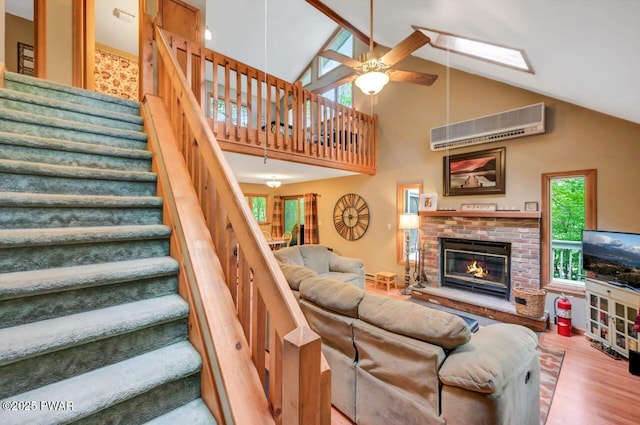 108 Minnow Ct, Lackawaxen, PA 18435 - living area with an AC wall unit, stairs, ceiling fan, wood finished floors, and high vaulted ceiling